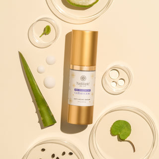 Gold skincare bottle with aloe vera leaves and other natural elements on a beige background