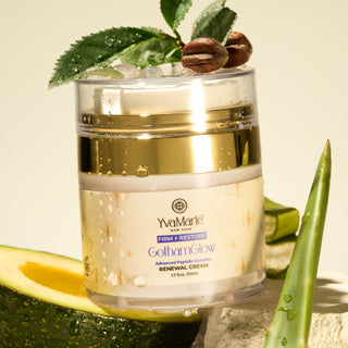 Jar of YvaMarie GothamGlow Renewal Cream with aloe vera and leaves on a light background
